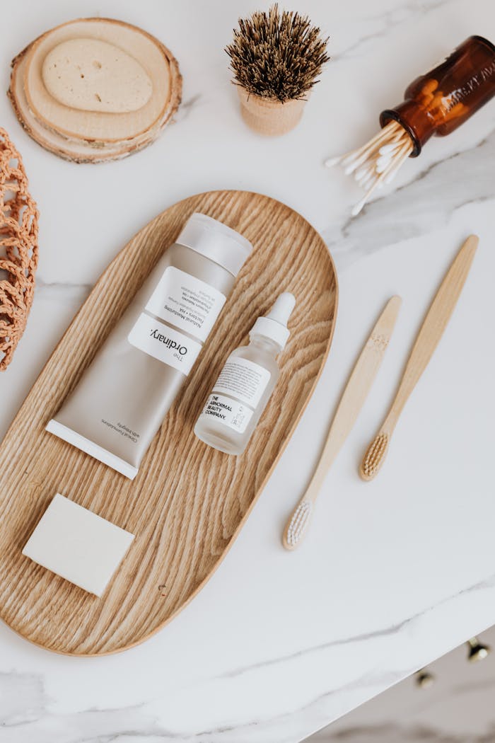 The Art of Drawing Readers In: Your attractive post title goes here Modern minimalist flat lay featuring sustainable skincare and oral care items on wooden tray.